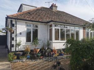 a house with a lot of plants in front of it at Sunny Family Residence with parking. Jacuzzi bath perfect for relaxing and unwinding in Kent