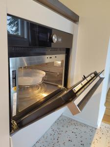 a microwave oven with a pan inside of it at steenkamp•studio Auntys' Chamber in Hamburg