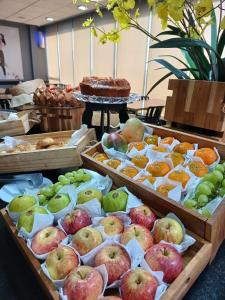 a display of different types of fruit in wooden trays at ibis Contagem Ceasa in Contagem