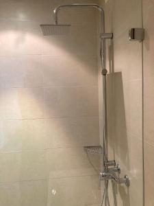 a shower in a bathroom with a glass door at Private room with work space near Zurich in Adliswil