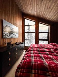 a bedroom with a bed and a dresser and a window at Norebu - Norefjell in Noresund
