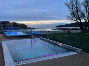 a swimming pool with a view of the water at Kristiansand, Bystranda 59m2, 2 soverom, 6 senger in Kristiansand