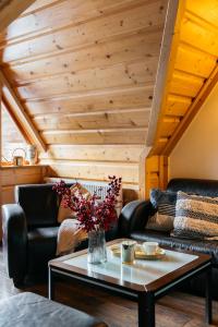 a living room with two leather couches and a table at Forest Home Zakopane by LoftAffair in Zakopane