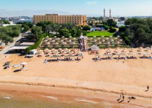 an aerial view of a beach with umbrellas at BM Beach Hotel in Ras al Khaimah