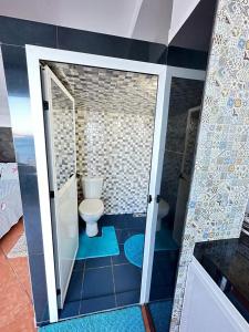 a bathroom with a toilet and a walk in shower at Belyounech studio location de vacance in Tétouan