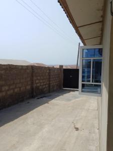 an empty garage with a window on the side of a building at Abakidoye Lodge in Ilora