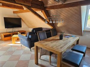 ein Esszimmer mit einem Holztisch und Stühlen in der Unterkunft Weitblick in Öhningen