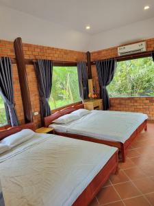 Postel nebo postele na pokoji v ubytování Homestay Nam Hàm Luông