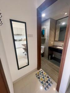 a bathroom with a mirror and a sink at Luxury Apartment, Harbour Bay in Jodoh