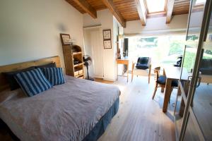 a bedroom with a bed and a table and a dining room at Casa Pirineu in Alp
