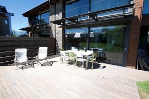 a patio with a table and chairs on a deck at Casa Pirineu in Alp
