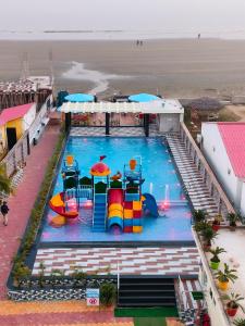 an overhead view of a pool with a water park at Hindusthan Inn - On Beach in Mandarmoni