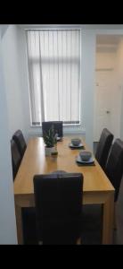 a dining room table with black chairs around it at Ensuite room in West Midlands in Parkside