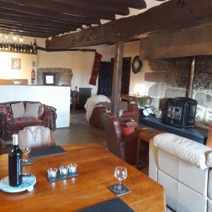 a living room with a table and a couch at Le Calipel in Saint-Vigor-des-Monts