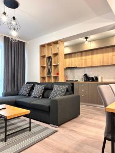 a living room with a couch and a kitchen at Industrial style in Bucharest
