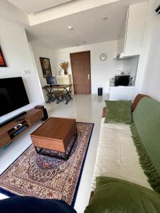 a living room with two couches and a tv at Luxury Apartment, Harbour Bay in Jodoh