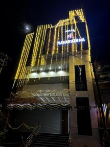 a building with a sign on it at night at Navarathna Comforts in Madikeri