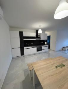una gran cocina con una mesa de madera en una habitación en Fancy Big Apartment, en Gerasdorf bei Wien
