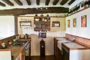 a kitchen with a sink and a stove top oven at Le Calipel in Saint-Vigor-des-Monts