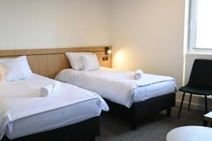 Postel nebo postele na pokoji v ubytování Hotel Parrot