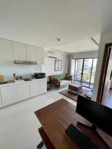 a kitchen and living room with a wooden table at Luxury Apartment, Harbour Bay in Jodoh