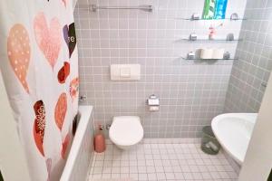 a small bathroom with a toilet and a sink at Double Room by Interlaken. Parking in Därligen