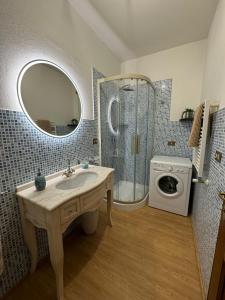 a bathroom with a sink and a washing machine at La Casina di Maya in Livorno