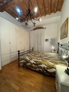 a bedroom with a bed and a chandelier at La Casina di Maya in Livorno