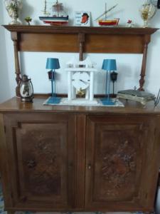 a wooden cabinet with two lamps on top of it at B&B Antico Palmento in Lipari