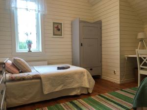 a bedroom with a bed and a window and a door at Bashults Gård in Jönköping