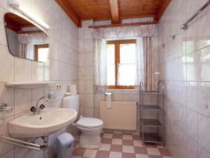 a white bathroom with a sink and a toilet at Cosy holiday home near ski area in Wagrain