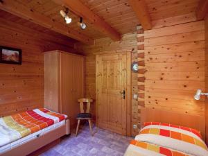 a bedroom with two beds in a log cabin at Cosy holiday home near ski area in Wagrain