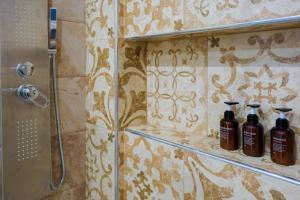 a bathroom with two shampoo bottles on a shelf at NGsuite cityspot Volos in Volos