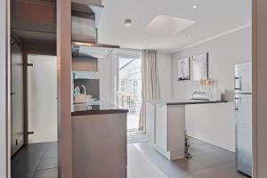a kitchen with a counter top and a refrigerator at Touristflat Dewulf in Ghent