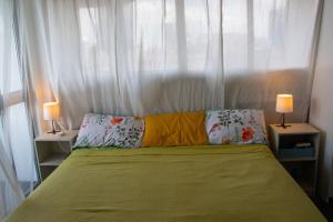 a bedroom with a bed with two lamps and a window at Serene Sea View By Chana in Colombo