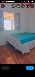 a bedroom with a bed with a white bed skirt at Dunas Mar em Guajiru in Trairi