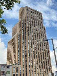 a large tall building with a sky at Apartaestudio Bogotá Colombia in Bogotá