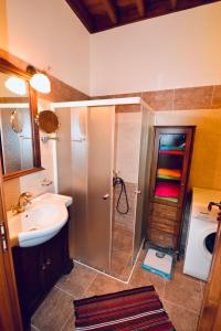a bathroom with a shower and a sink and a shower at Villa Patitiri Traditional House in Archangelos