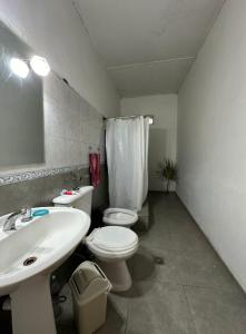 a bathroom with a sink and a toilet and a mirror at Habitacion INDIVIDUAL en casa compartida- cama individual in Villa Marini