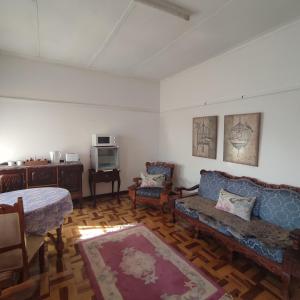a living room with a couch and two chairs at Rehati Guesthouse in Potchefstroom