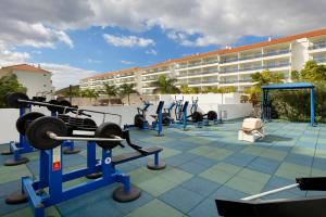 a row of exercise equipment in front of a building at Marinell Collection Palm-Mar Apartments in Palm-mar