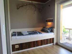 a bed in the corner of a room at Ferienhaus Schau ins Land - eigene Panorama-Sauna in Schöfweg