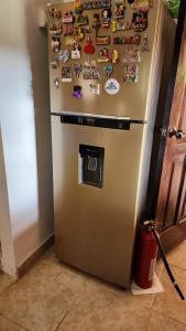 a refrigerator with magnets on it in a kitchen at El Zumbito in Valle de Anton