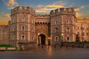 a large castle with a sunset in the background at Epic Location, Views & Large Private Terrace in Windsor