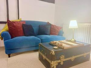 a blue couch with pillows and a trunk in a living room at Epic Location, Views & Large Private Terrace in Windsor