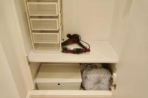 a white cabinet with a magnifying glass in it at Epic Location, Views & Large Private Terrace in Windsor