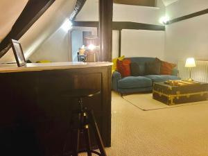 a living room with a couch and a bar with a stool at Epic Location, Views & Large Private Terrace in Windsor