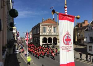 a parade in front of a building with a flag at Epic Location, Views & Large Private Terrace in Windsor