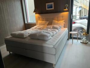 a large bed in a room with aermott at Waterfront apartment with panoramic sea view in Henningsvær