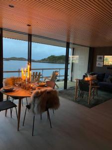 a living room with a table with candles on it at Waterfront apartment with panoramic sea view in Henningsvær